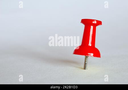 Red push pin. Closeup of red thumbtack Stock Photo