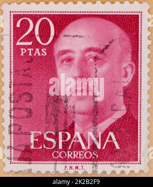 Photo of a red 20 pesetas Spanish postage stamp featuring an image of Francisco Franco Bahamonde from 1955 Stock Photo