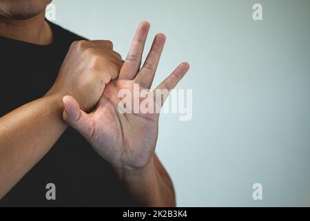 Office syndrome concept. Index finger is massaged and stretched after working. Close up shot with copy space. Forehand view. Stock Photo