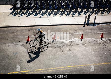 New York City street with rental bikes and a cyclist on the road see from above Stock Photo