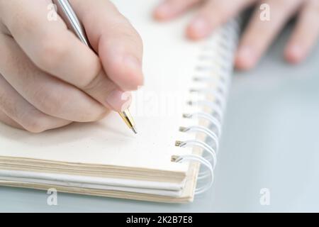 Hands working writing notebook on desk Stock Photo