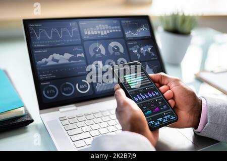 African Advisor Using KPI Dashboard Stock Photo