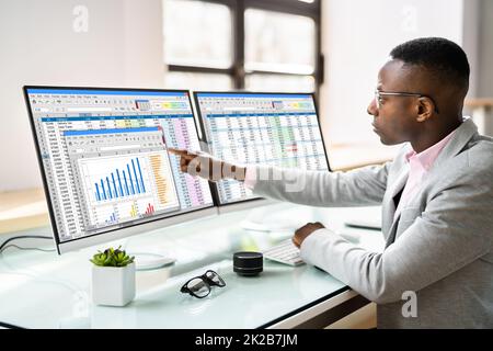 Data Analyst African Man Using Spreadsheet Stock Photo