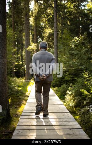 Senior man enjoying the outdoors, hiking, walking throught lovely nature Stock Photo
