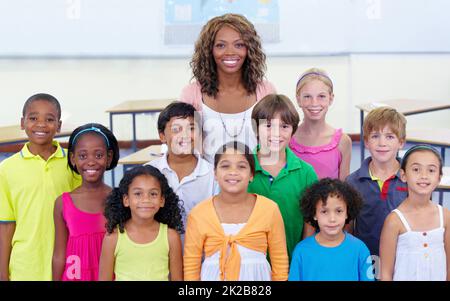 Class picture. Class portrait of an elementary school teacher and her pupils. Stock Photo