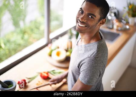 Hey, no peeking on my secret recipy. Aerial shot of an african man. Stock Photo