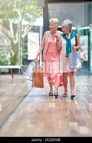 Theres a sale that caught my attention. Full length shot of a two senior women out on a shopping spree. Stock Photo