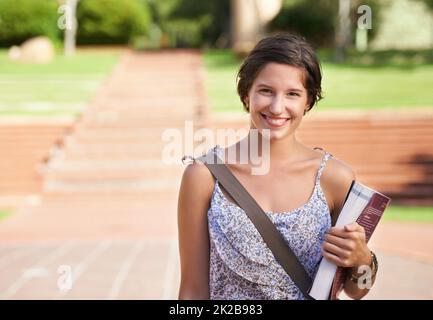 Preparing for a bright future. A beautiful young student standing on campus smiling at the camera. Stock Photo