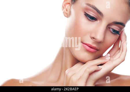 Soft to the touch. Studio shot of a beautiful young woman isolated on white. Stock Photo