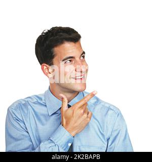 Pointing towards a solution. Studio shot of a young businessman looking thoughtful against a white background. Stock Photo