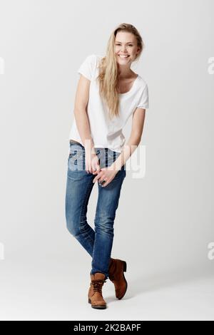 Shes happy-go-lucky. Full length studio portrait of a happy and attractive young woman. Stock Photo