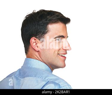 Looking back to where it all started. Studio shot of a young businessman looking back over his shoulder against a white background. Stock Photo