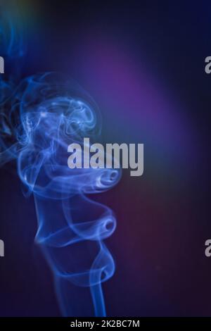 Smoky clouds on blue and black background Stock Photo
