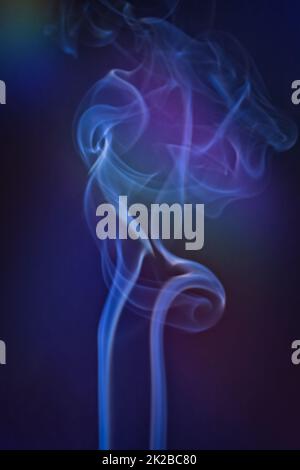 Smoky clouds on blue and black background Stock Photo