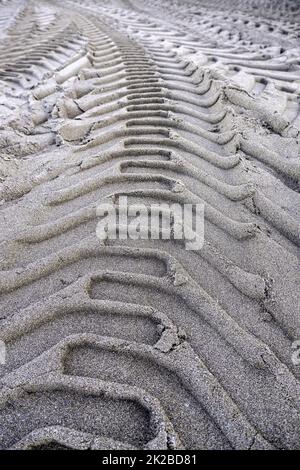 Wheel tracks on the beach Stock Photo