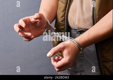 men's hands in metal handcuffs Stock Photo