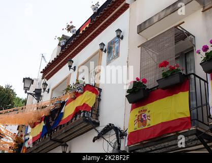 facade of houses in the Santa Cruz neighborhood of Alicante with the flag of Spain Stock Photo