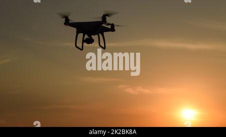 drone silhouette against the background of the sunset Stock Photo