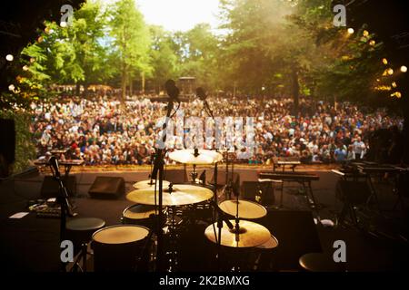 REady to rock. Cropped shot of a musicians feet on stage at an outdoor music festival. Stock Photo