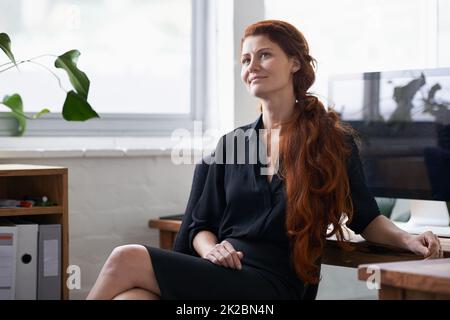 Dont quit your daydream. Shot of a beautiful young businesswoman sitting at her desk. Stock Photo