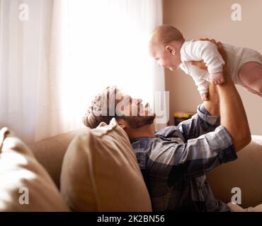 Daddys little angel. Shot of a father playing with his baby boy. Stock Photo