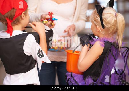 Trick or treat. Shot of children trick or treating. Stock Photo