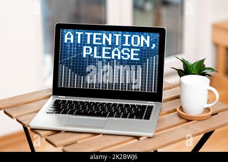 Hand writing sign Attention, Please. Business approach way to attract when there is something to announce Laptop Resting On A Table Beside Coffee Mug And Plant Showing Work Process. Stock Photo