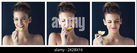 When life gives you lemons, eat them for optimal health. Composite image of a beautiful young woman eating a slice of lemon. Stock Photo