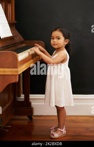 Virtuoso in the making. Cropped shot of a little girl playing the piano. Stock Photo