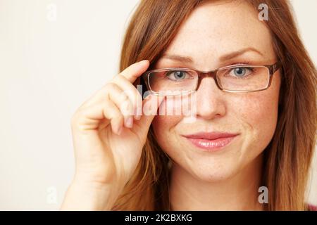 Shes one smart cookie. Cropped portrait of a beautiful young redhead wearing glasses. Stock Photo