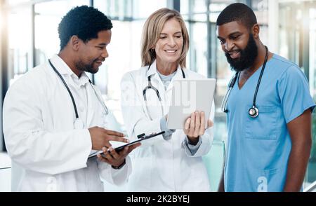 Doctors, meeting and tablet for healthcare planning using information technology for medical development, talking about medicine. Healthcare team Stock Photo