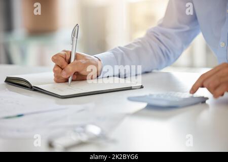Accountant, notebook and audit budget with calculator while analyzing paperwork and doing finance planning in home. Hands of businessman writing doing Stock Photo