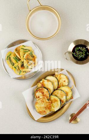 Top View Hobak Jeon and Pajeon, Korean Traditional Vegetable Pancake. Served with Makgeolli Stock Photo