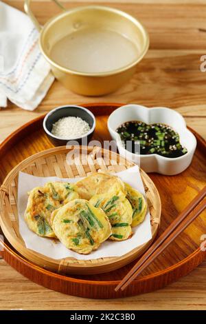 Homemade Korean Pajeon Scallion Chives Pancakes with Dipping Sauce and Sesame Seed. Eat with Makgeolli. Stock Photo