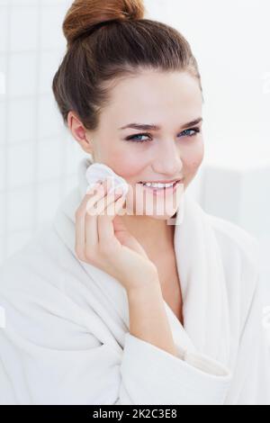 Subtly beautiful. A gorgeous teenage girl cleaning her skin. Stock Photo