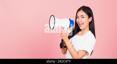 woman teen confident smiling face holding making announcement message shouting screaming in megaphone Stock Photo