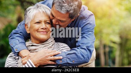 Having you around always makes me feel better. Shot of an affectionate senior couple spending some time together at the park. Stock Photo