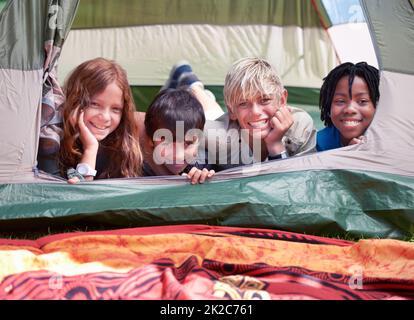 https://l450v.alamy.com/450v/2k2c761/we-love-camping-four-friends-lying-in-a-tent-together-and-smiling-happily-2k2c761.jpg