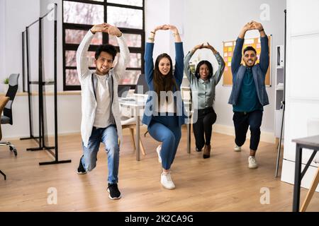 Group Of Happy Young Businesspeople Doing Stretching Exercise Stock Photo
