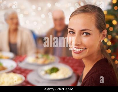 Get ready for a Christmas feast. A family sitting around the table at Christmas. Stock Photo