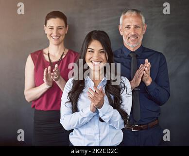 Well done. Studio portrait of a group of coworkers giving you a round of applause. Stock Photo
