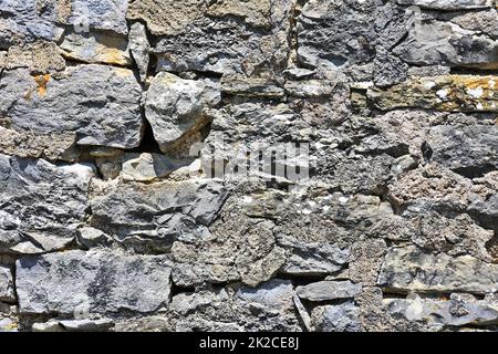 Wall made of irregular rubble stone as a background Stock Photo