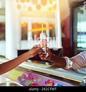 Theres always time for ice cream. Shot of a young woman enjoying an ice cream. Stock Photo