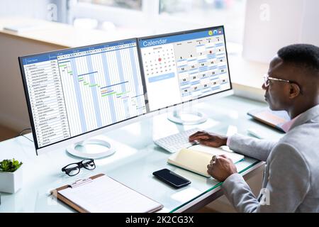 Employee Working On Calendar Schedule Stock Photo