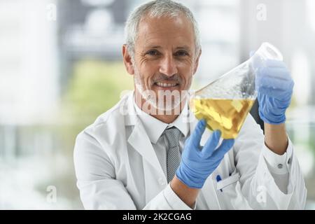 I think ive got a breakthrough. Portrait of a researcher working with beakers in a lab. Stock Photo