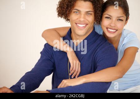 Were embarking on a bright future. Gorgeous mixed race couple smiling affectionately for the camera. Stock Photo
