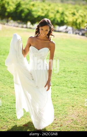 Bridal beauty. A beautiful bride standing in front of a vineyard. Stock Photo