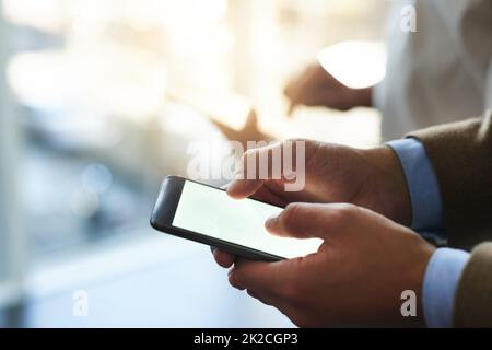 Pave your way by staying connected. Cropped shot of a businessman using his cellphone. Stock Photo