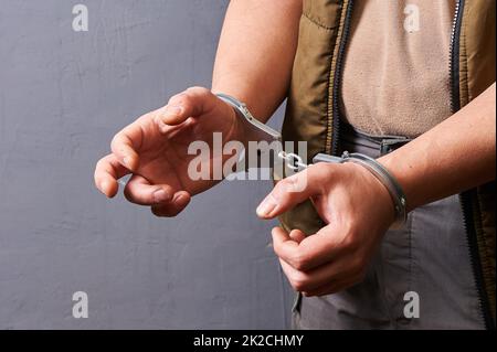 men's hands in metal handcuffs Stock Photo