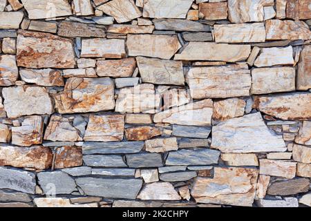 Rustic stone wall texture or background Stock Photo